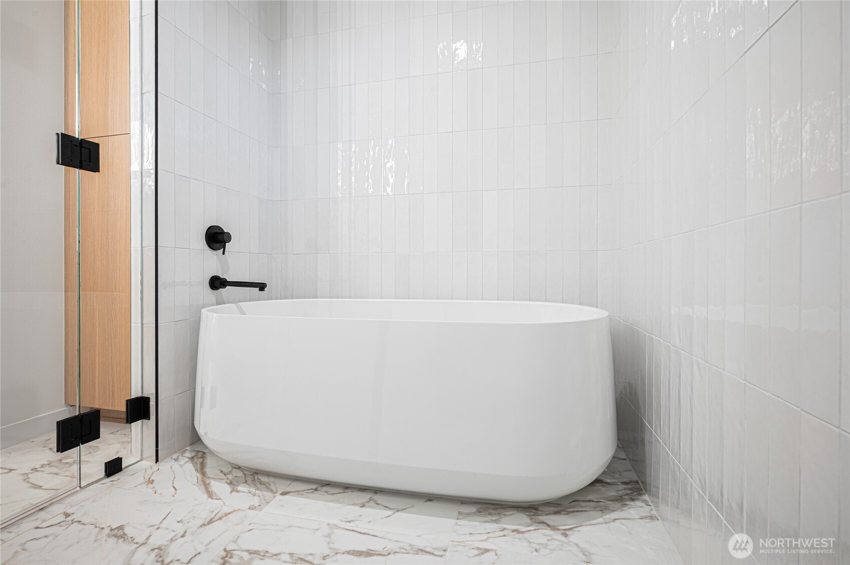 1176 129th Avenue Southeast Bellevue, WA 98005 - Photo 20 of 32 a white bath tub sitting in a bathroom