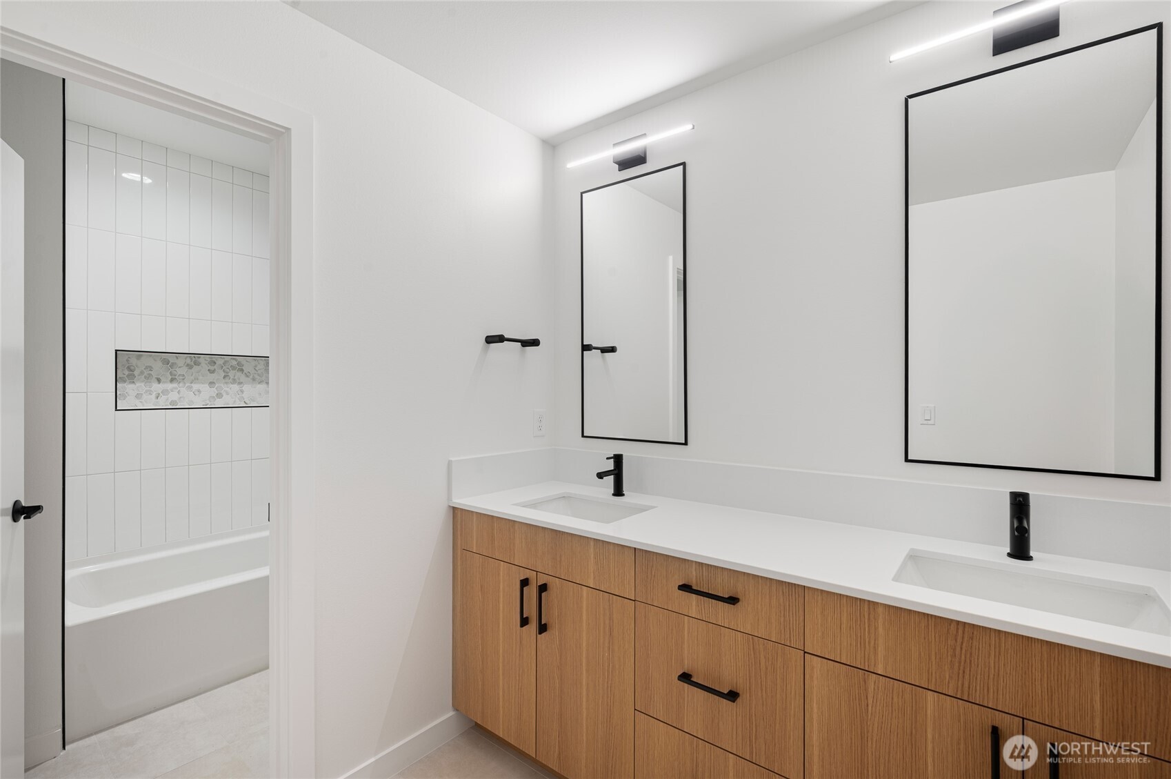 1176 129th Avenue Southeast Bellevue, WA 98005 - Photo 23 of 32 a bathroom with a double vanity sink and mirror