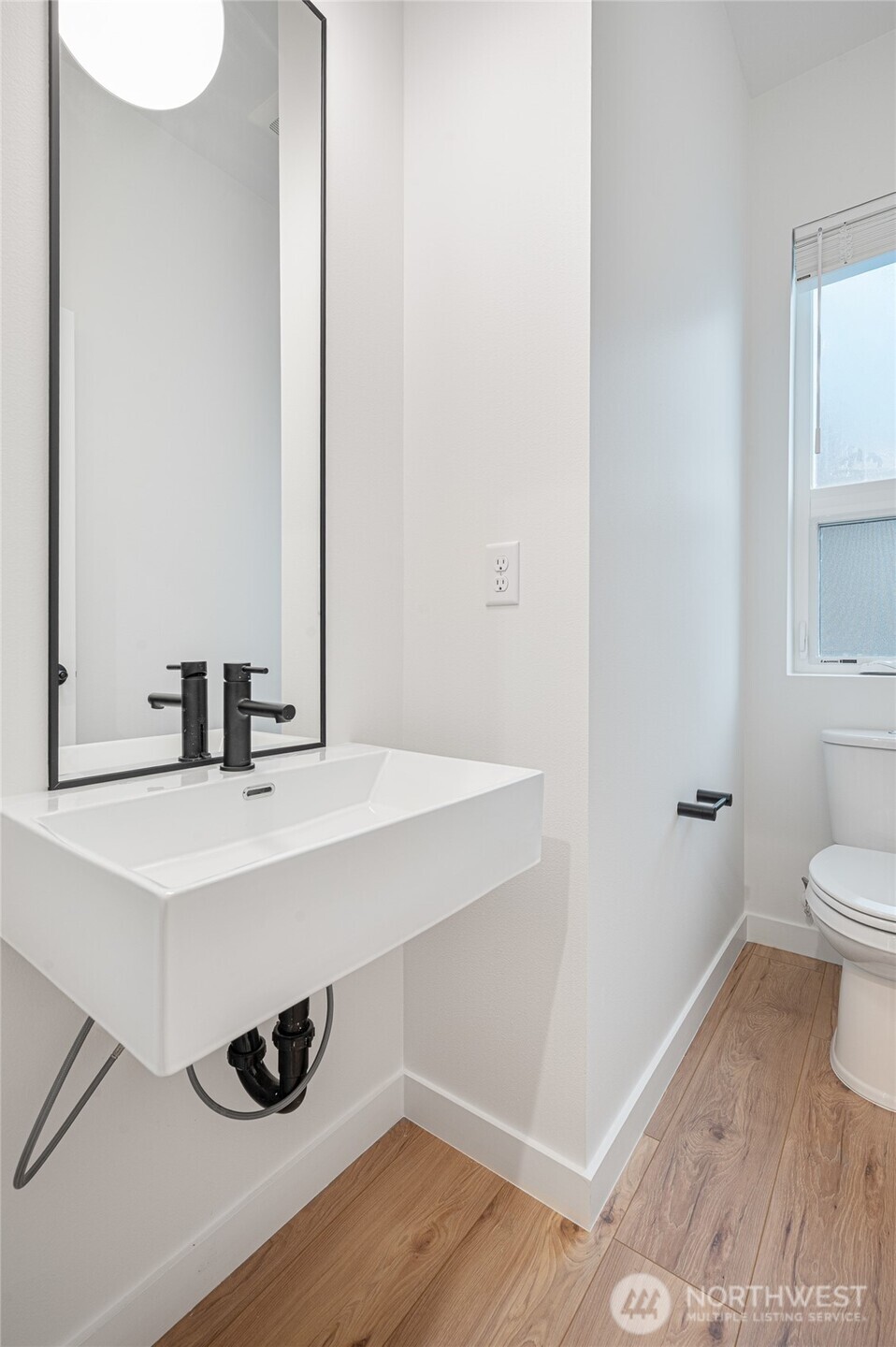 1176 129th Avenue Southeast Bellevue, WA 98005 - Photo 26 of 32 a bathroom with a sink and a mirror
