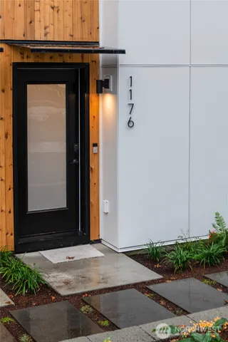 a view of a kitchen with a sink and wooden floor
