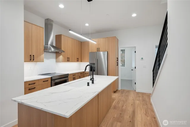 a kitchen with a sink a refrigerator and a stove