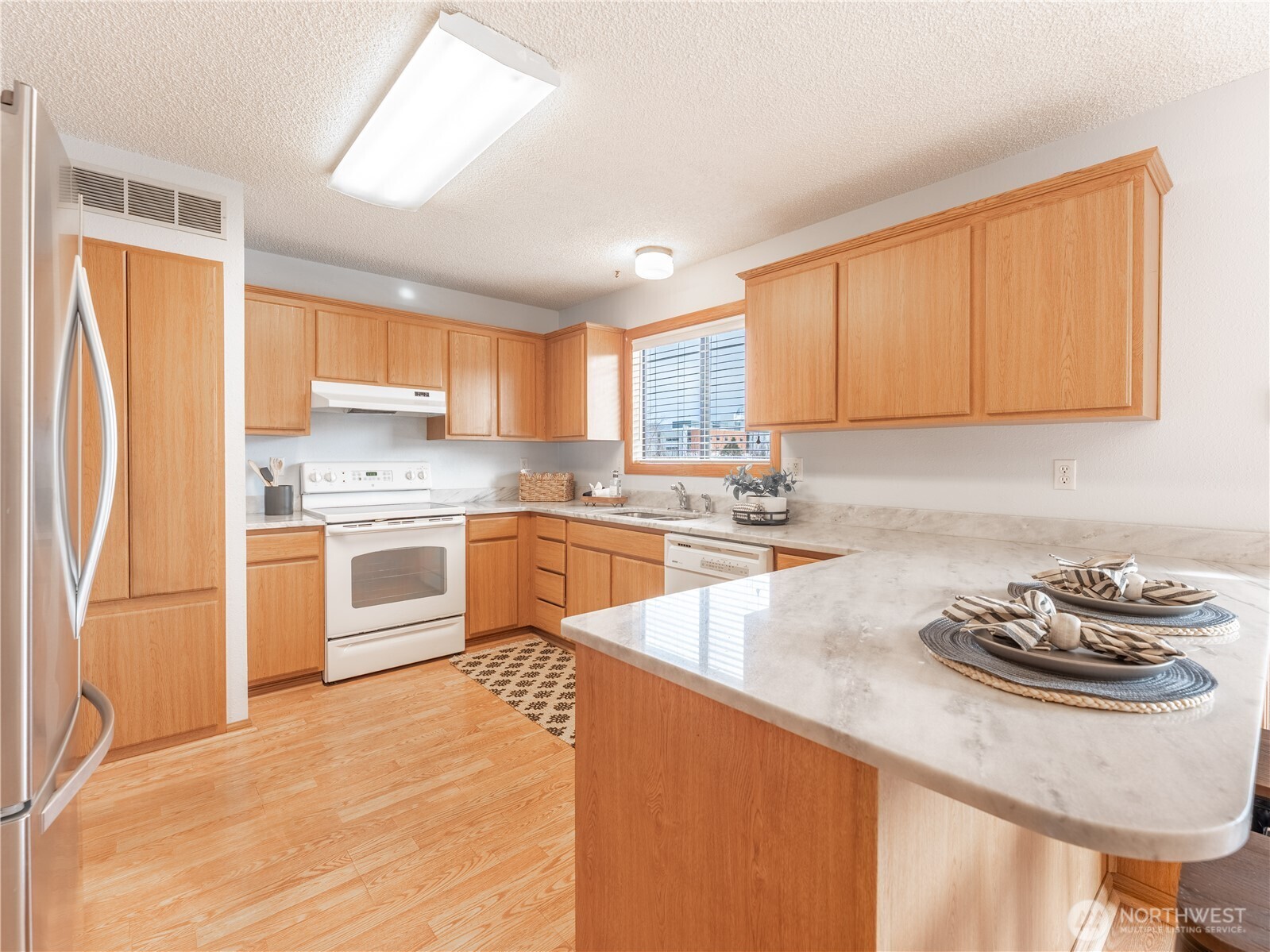 1317 Wedgewood Avenue Wenatchee, WA 98801 - Photo 14 of 39 a kitchen with a sink stove and refrigerator