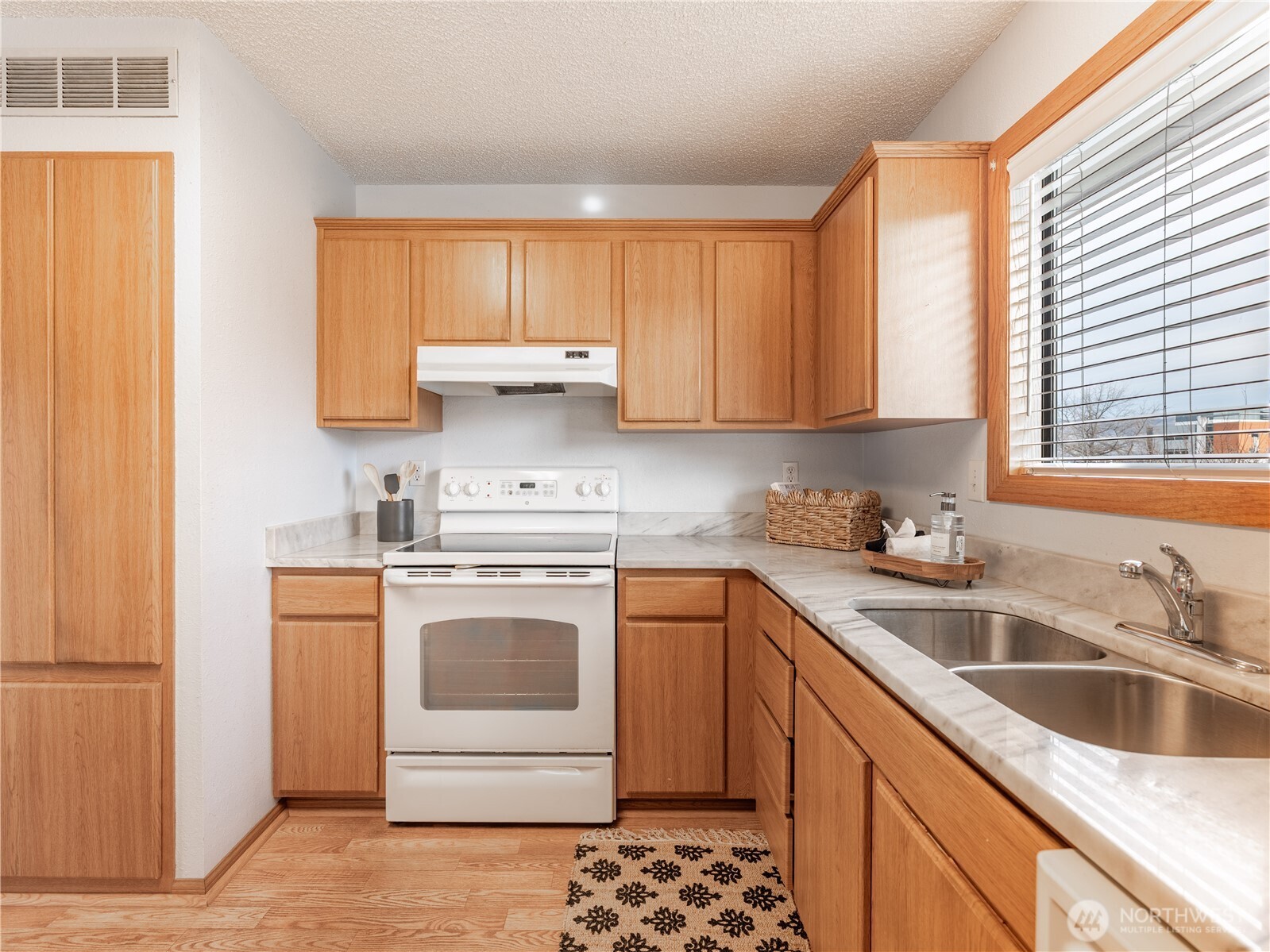 1317 Wedgewood Avenue Wenatchee, WA 98801 - Photo 16 of 39 a kitchen with a sink stove top oven and cabinets