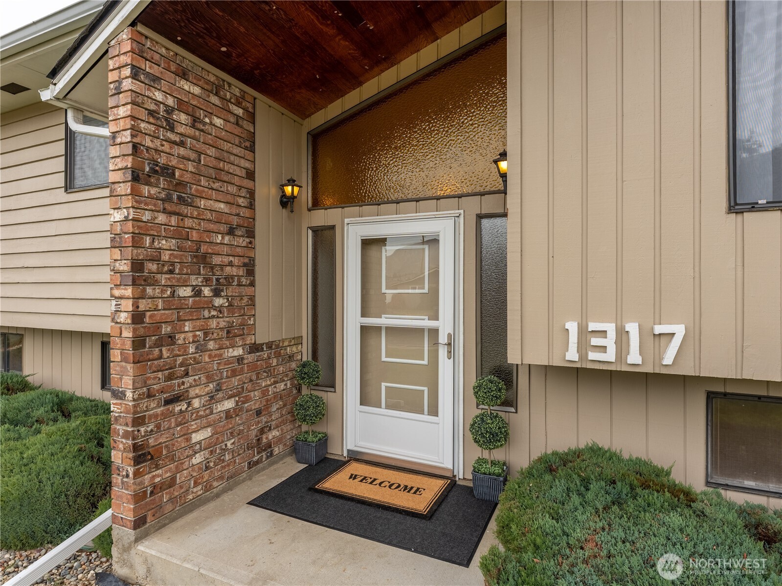 1317 Wedgewood Avenue Wenatchee, WA 98801 - Photo 2 of 39 a backyard of a house with barbeque oven and outdoor seating