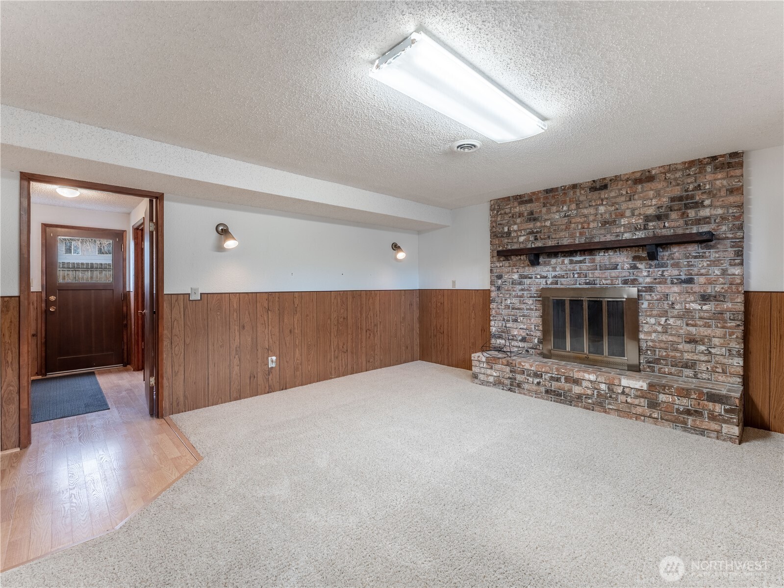 1317 Wedgewood Avenue Wenatchee, WA 98801 - Photo 25 of 39 wooden floor in an empty room with a fireplace