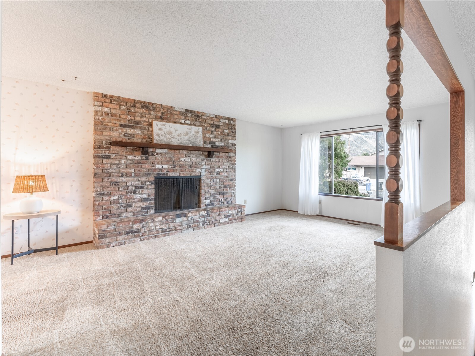 1317 Wedgewood Avenue Wenatchee, WA 98801 - Photo 6 of 39 a view of an empty room with a fireplace and a window