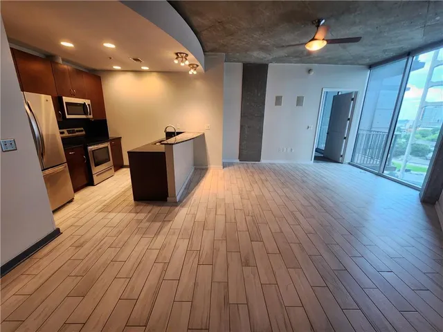 a view of a living room with wooden floor