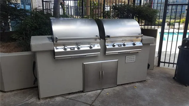 a metallic refrigerator freezer sitting inside of a kitchen
