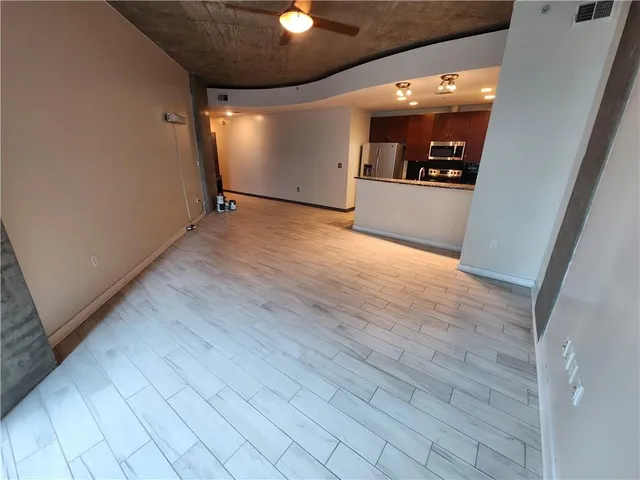 a view of a room with wooden floor