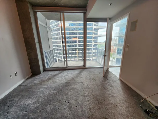 a view of empty room with floor to ceiling window