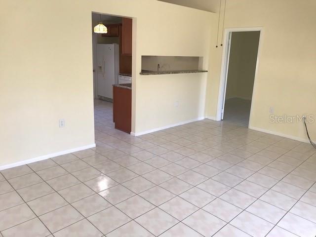715 Caribou Drive Kissimmee, FL 34759 - Photo 4 of 13 an empty room and wooden door