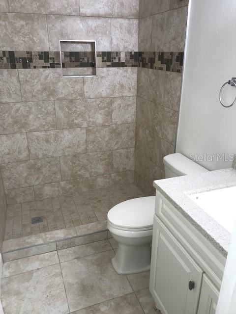 715 Caribou Drive Kissimmee, FL 34759 - Photo 9 of 13 a white toilet sitting next to a bathroom sink