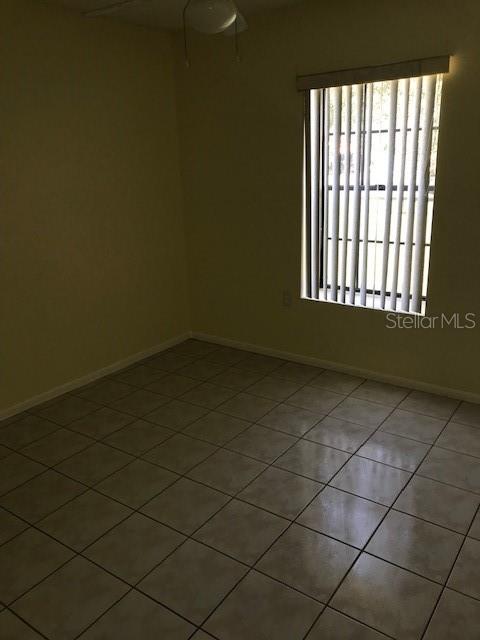 715 Caribou Drive Kissimmee, FL 34759 - Photo 10 of 13 an empty room with a empty space and a window