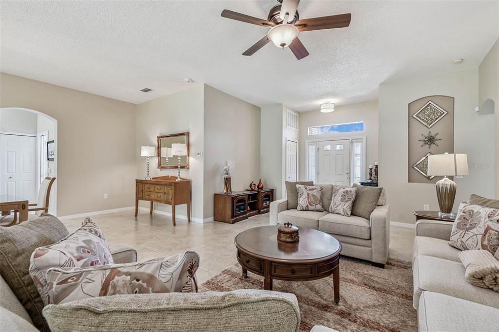 12202 Aaron Terrace Trinity, FL 34655 - Photo 8 of 41 a living room with furniture and a wooden floor