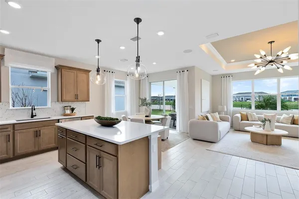a kitchen with stainless steel appliances granite countertop a sink a stove and a wooden floors