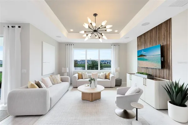 a living room with furniture potted plant and a large window