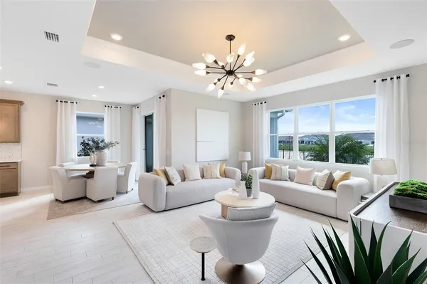 a living room with patio couches and a potted plant