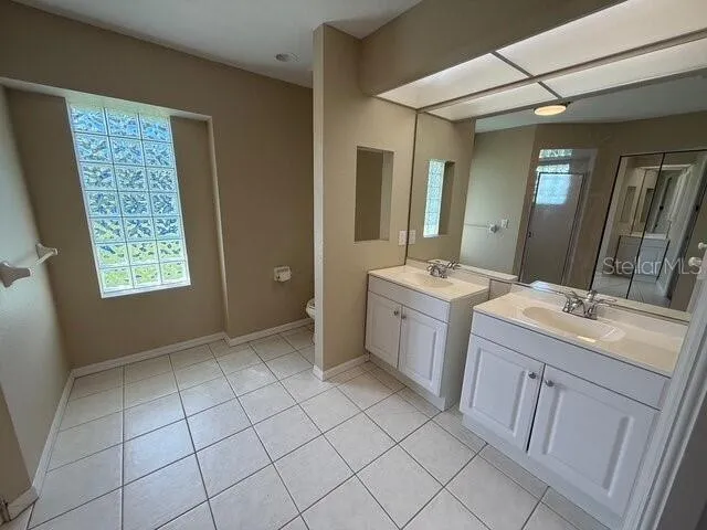 a bathroom with a sink toilet and mirror