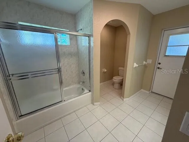 a bathroom with a sink a toilet and a shower