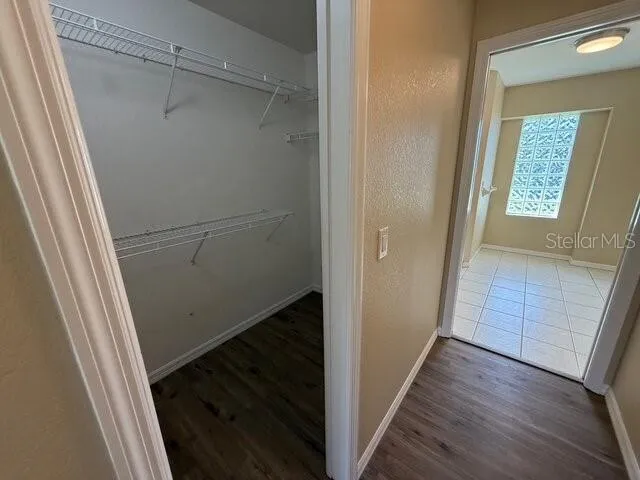 a view of storage and utility room with wooden floor