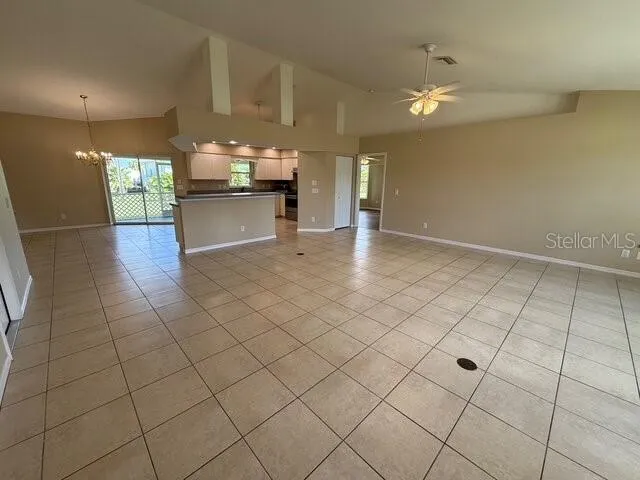 a view of kitchen and dining area with chandelier