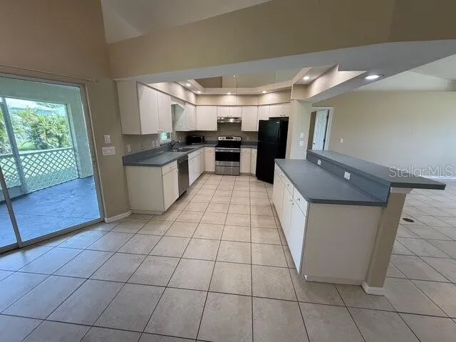 a kitchen with stainless steel appliances granite countertop a sink and cabinets