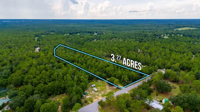 a view of a green field with sitting area