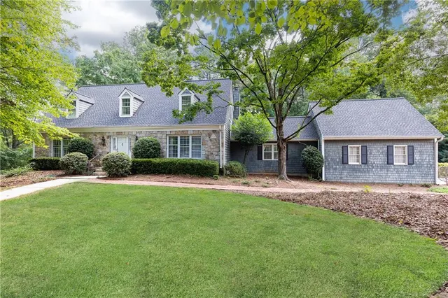a front view of a house with a garden