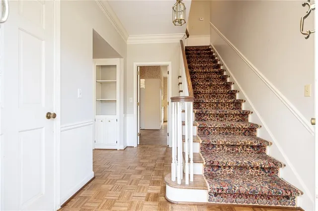 a view of a hallway with wooden floor and entryway