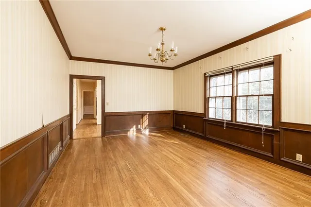 a view of a room with wooden floor and windows