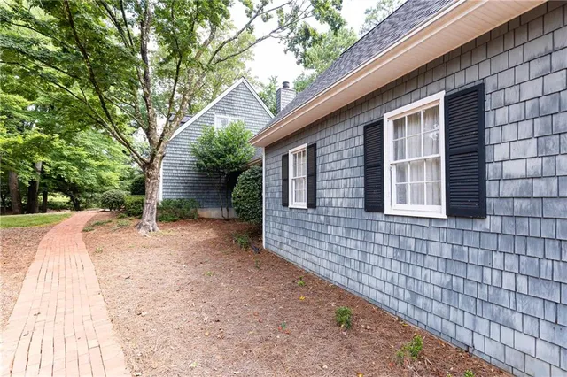 a pathway of a house with backyard