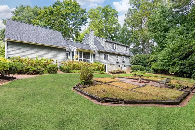 a view of a house with a garden and plants