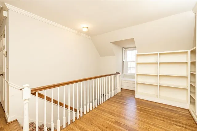 a view of a hallway with wooden floor and entryway