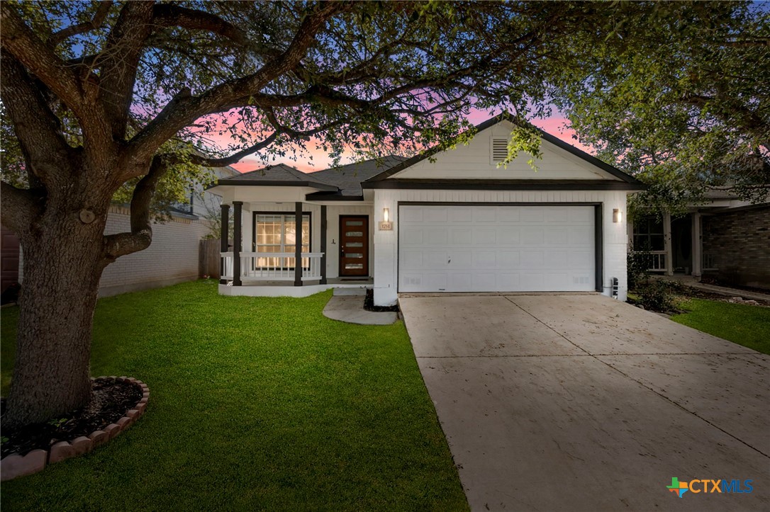 1751 Joy Spring New Braunfels, TX 78130 - Photo 1 of 35 a front view of a house with a garden and yard