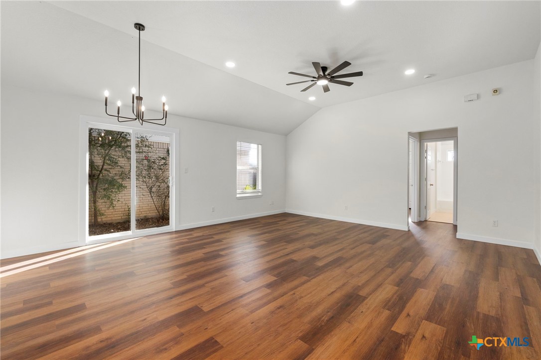1751 Joy Spring New Braunfels, TX 78130 - Photo 11 of 35 a view of a livingroom with a chandelier fan windows and wooden floor