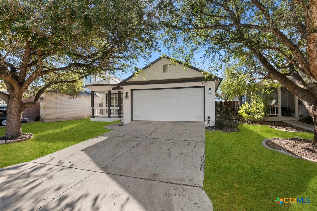 1751 Joy Spring New Braunfels, TX 78130 - Photo 2 of 35 a front view of a house with a yard and garage