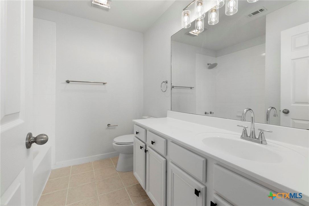 1751 Joy Spring New Braunfels, TX 78130 - Photo 21 of 35 a bathroom with a sink a toilet and shower