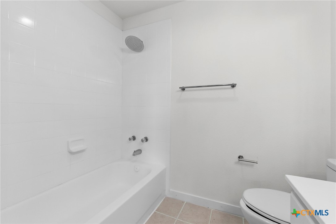 1751 Joy Spring New Braunfels, TX 78130 - Photo 22 of 35 a white bath tub sitting next to a white toilet and sink