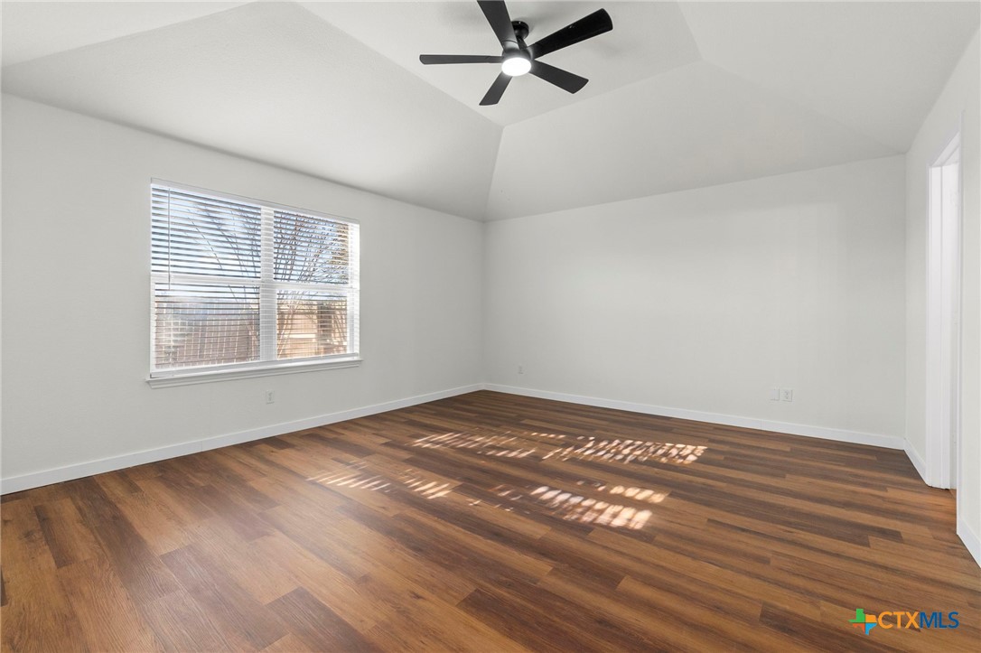 1751 Joy Spring New Braunfels, TX 78130 - Photo 23 of 35 a view of an empty room with wooden floor and a window