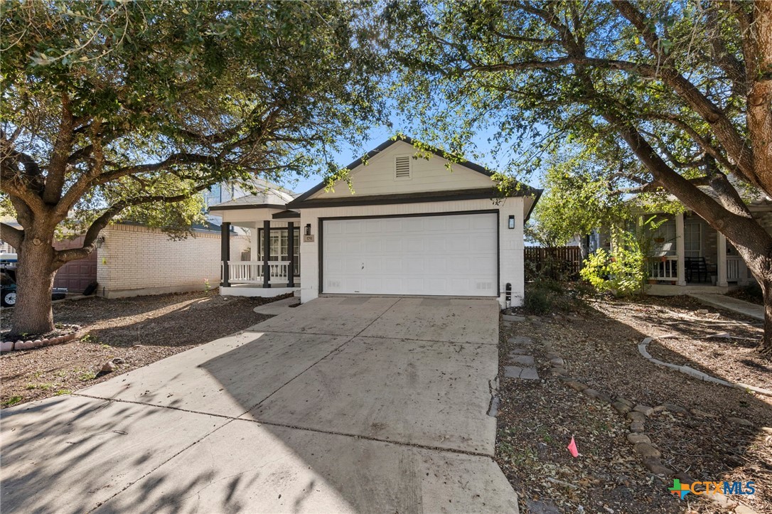 1751 Joy Spring New Braunfels, TX 78130 - Photo 33 of 35 a front view of a house with a yard and garage