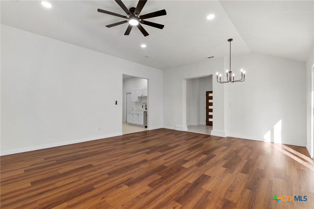 1751 Joy Spring New Braunfels, TX 78130 - Photo 9 of 35 a view of empty room with wooden floor and ceiling fan