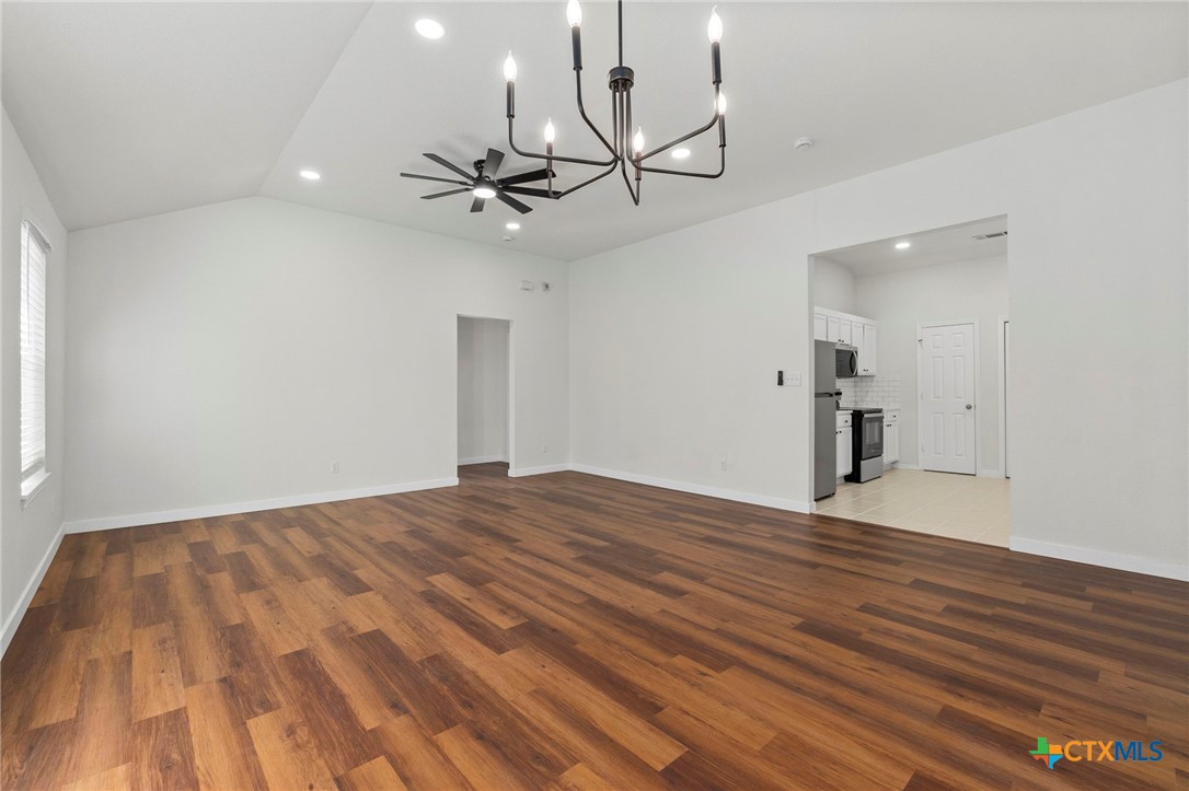 1751 Joy Spring New Braunfels, TX 78130 - Photo 10 of 35 a view of empty room with wooden floor and ceiling fan