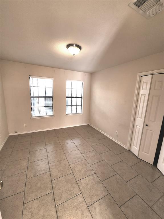 8811 Clearbrook Trail Austin, TX 78729 - Photo 6 of 38 lft A - Ceramic tile flooring spans this versatile room, illuminated by natural light and a flush-mount ceiling fixture.