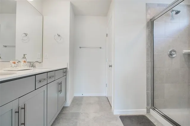 a bathroom with a double vanity sink and a mirror