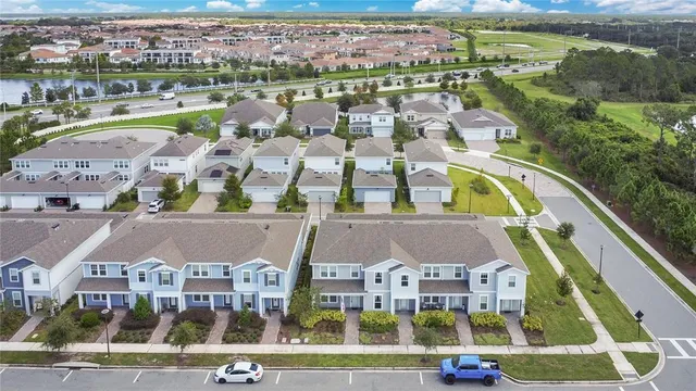 an aerial view of residential houses and lake view