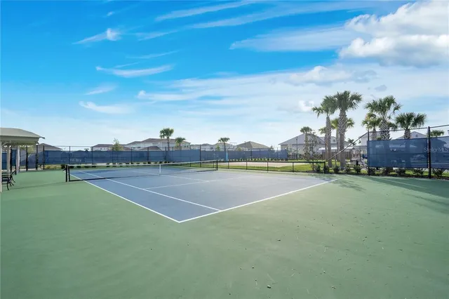 a front view of a house with large trees