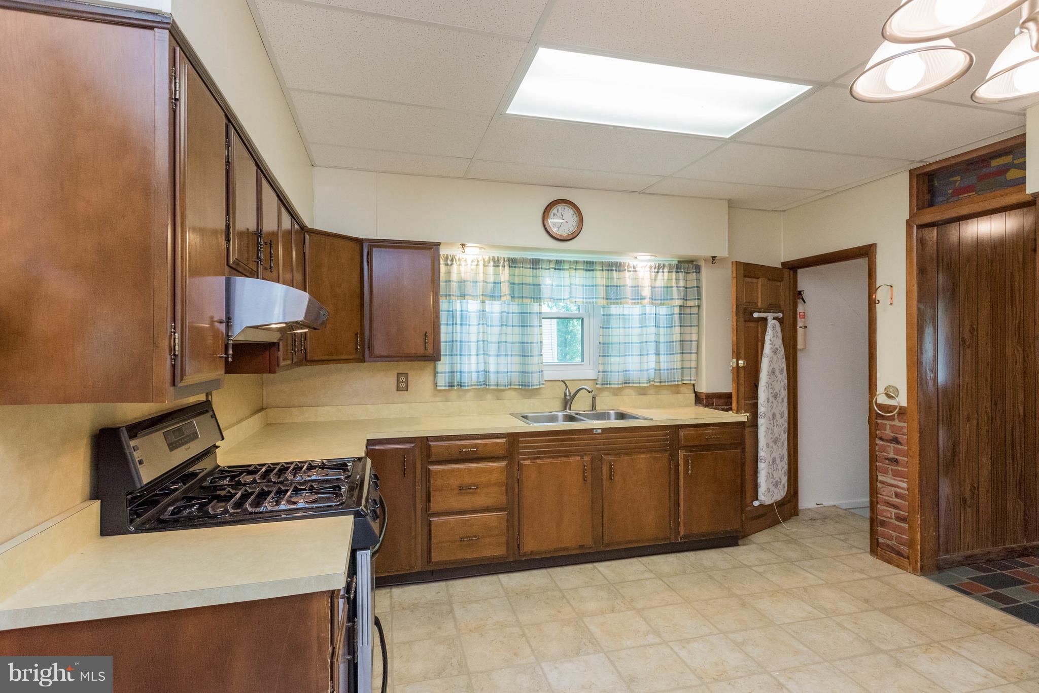 1404 Providence Road Baltimore, MD 21286 - Photo 9 of 26 a large kitchen with stainless steel appliances granite countertop a stove and a sink