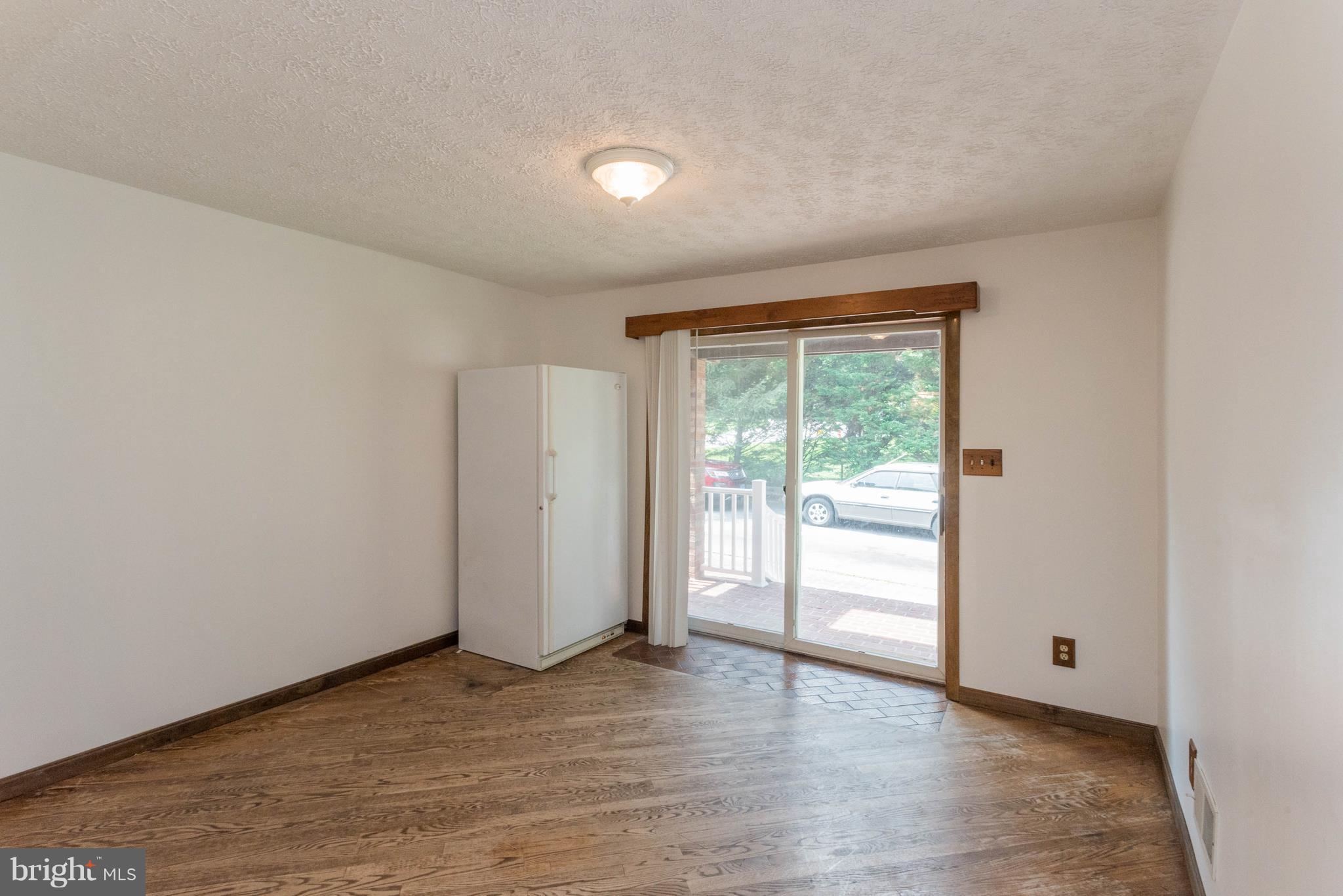 1404 Providence Road Baltimore, MD 21286 - Photo 10 of 26 a view of an empty room with wooden floor and a window