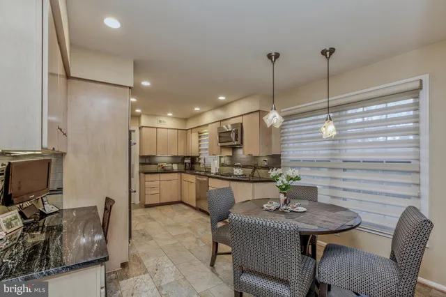a kitchen with a table chairs stove and microwave