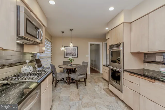 a kitchen with a stove a sink and a refrigerator